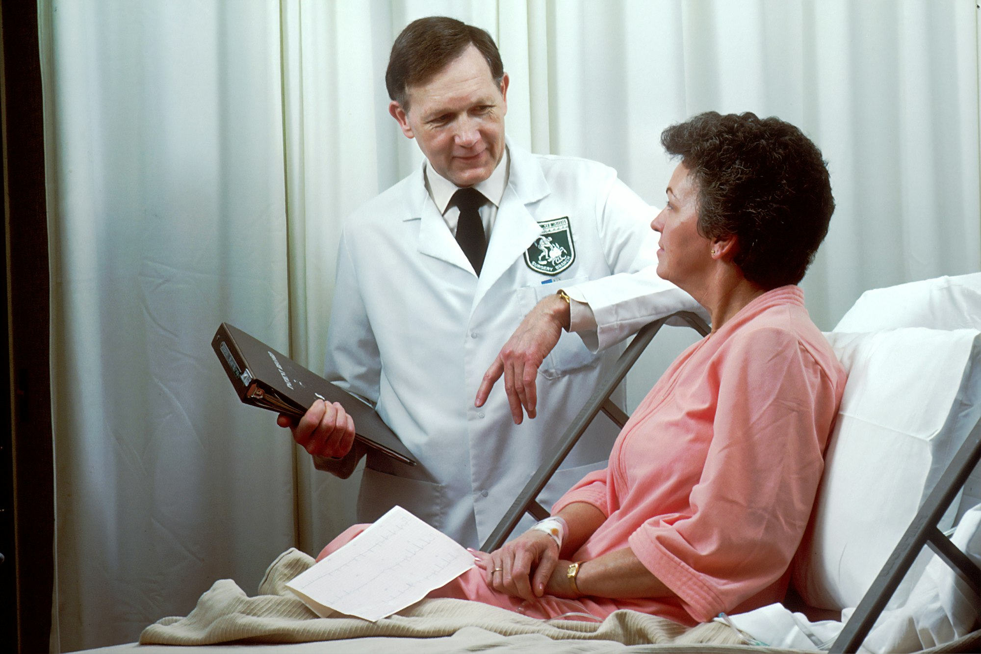 A nurse in scrubs reviewing notes